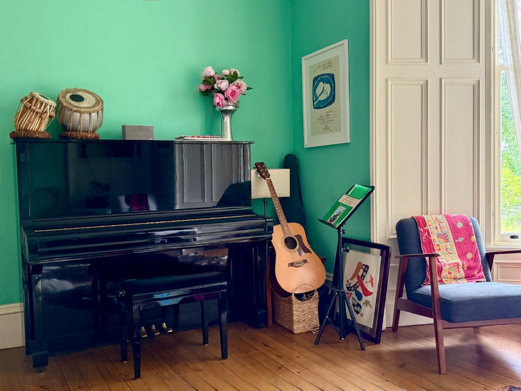 Music room with piano, guitar and tabla